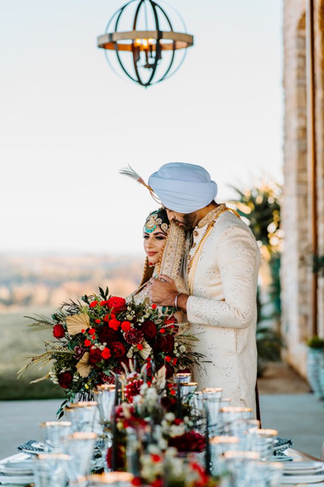 Bride and groom by the table setting.