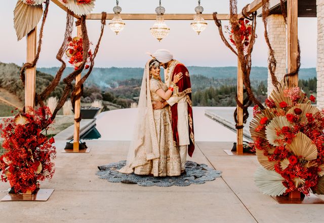 Palm leaves and red flower decore under the wedding arbor