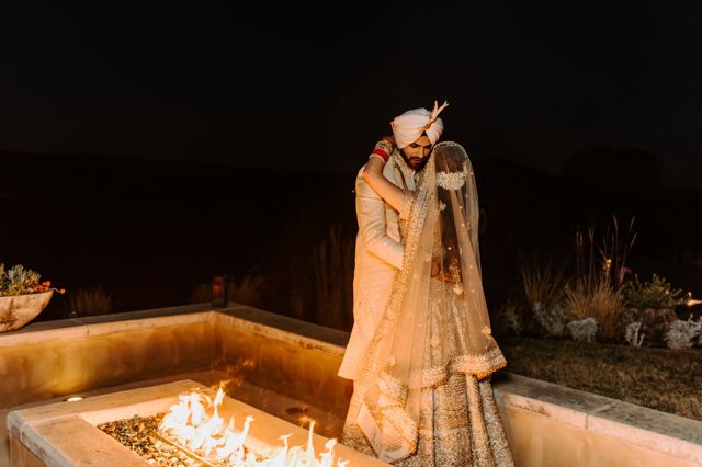 Couple by the fire at dusk.